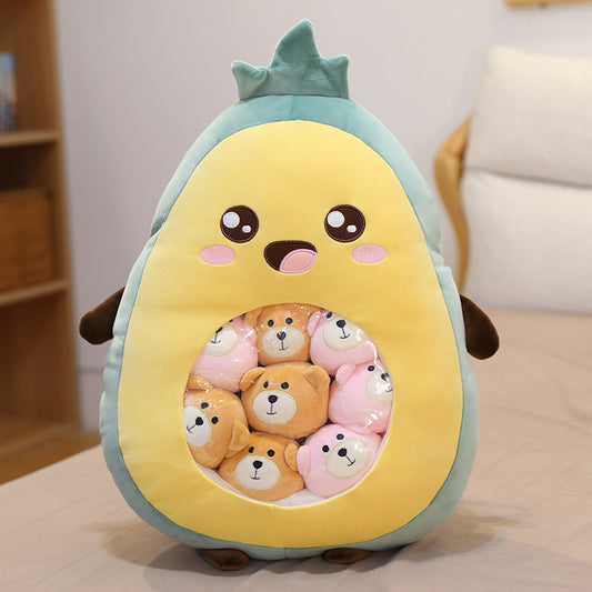 Plush toy shaped like an avocado with teddy bears inside on a light-colored surface.