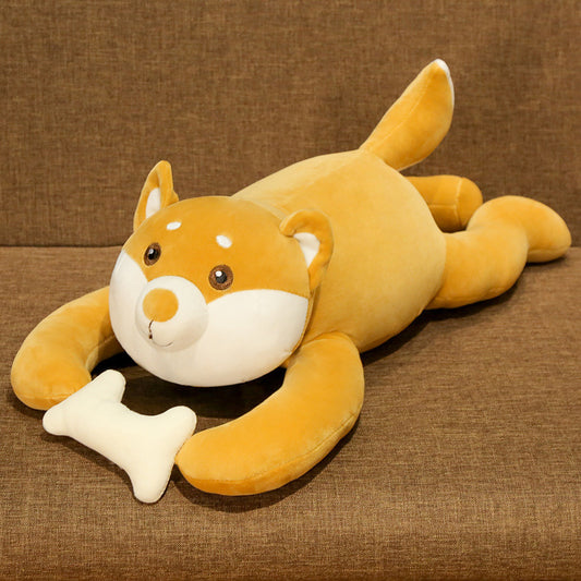 Plush toy dog lying on a brown surface