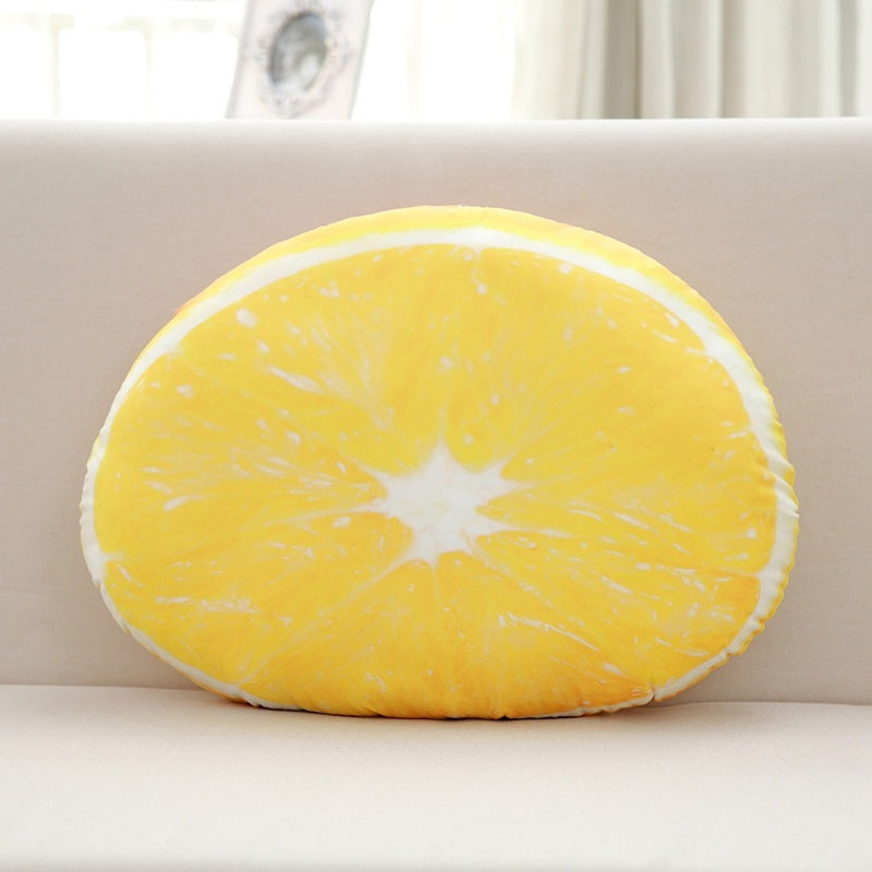 Round yellow lemon-shaped pillow on a beige sofa