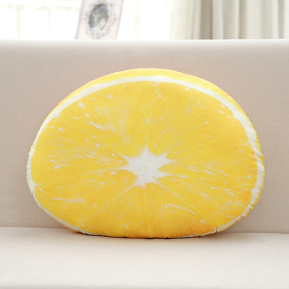Round yellow lemon-shaped pillow on a beige sofa