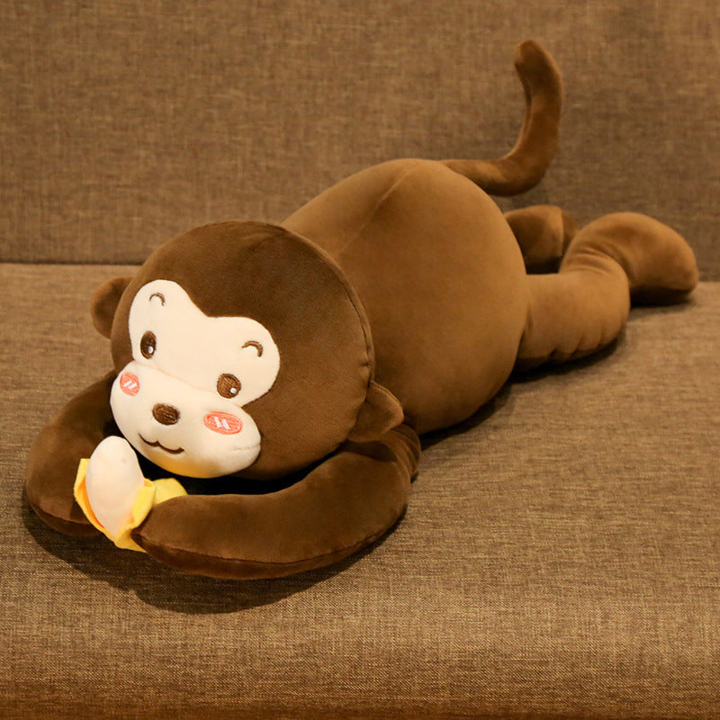 Brown monkey plush toy lying on a brown surface