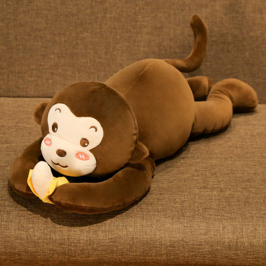 Brown monkey plush toy lying on a brown surface