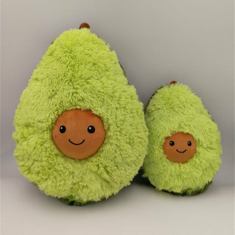 Two plush avocados with smiling faces on a plain background