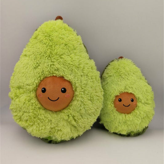 Two plush avocados with smiling faces on a plain background