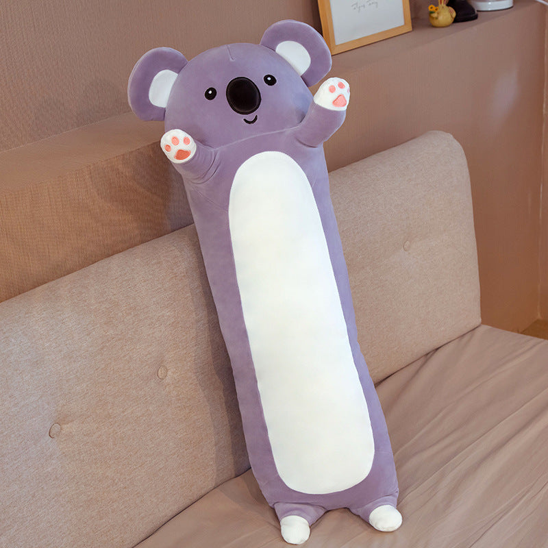 Purple koala-shaped pillow on a bed