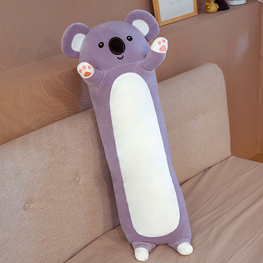 Purple koala-shaped pillow on a bed
