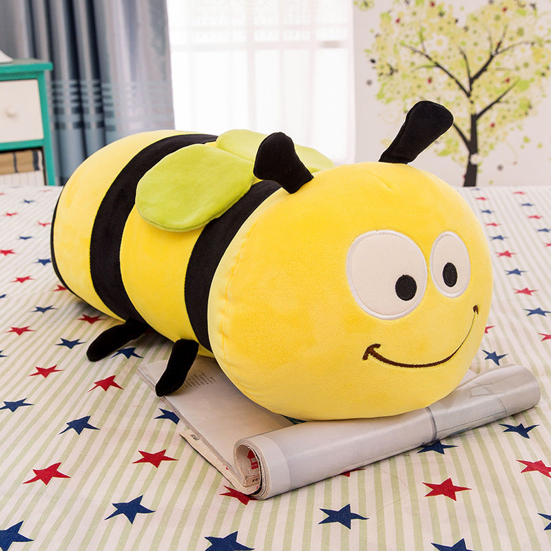 Plush bee toy on a bed with star-patterned bedding