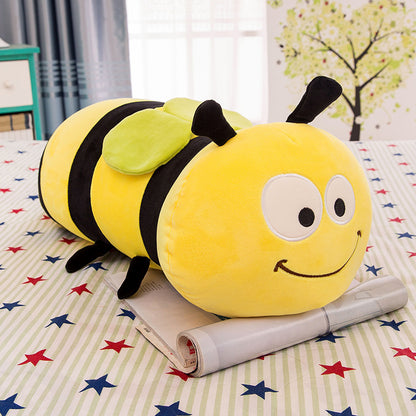 Plush bee toy on a bed with star-patterned bedding