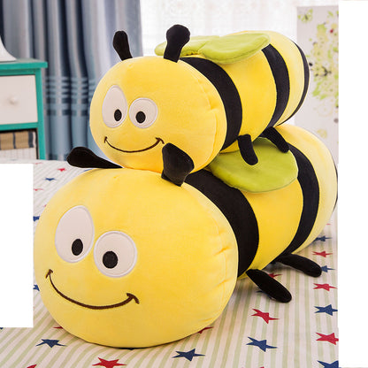 Plush toy shaped like a bee on a bed with colorful stars.