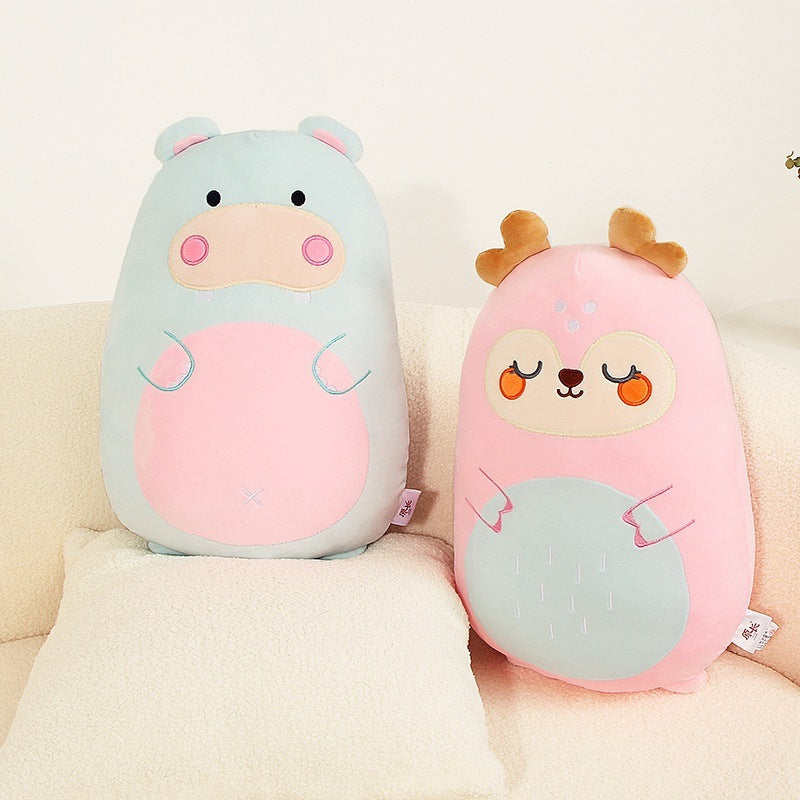 Two cute animal-shaped cushions on a beige couch.