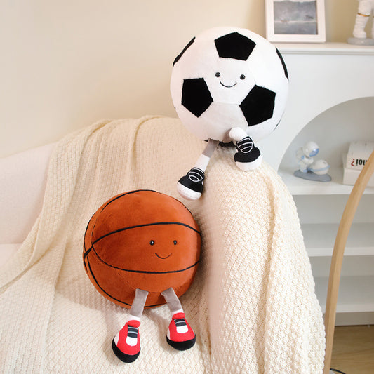 Plush toys shaped like a soccer ball and basketball on a couch