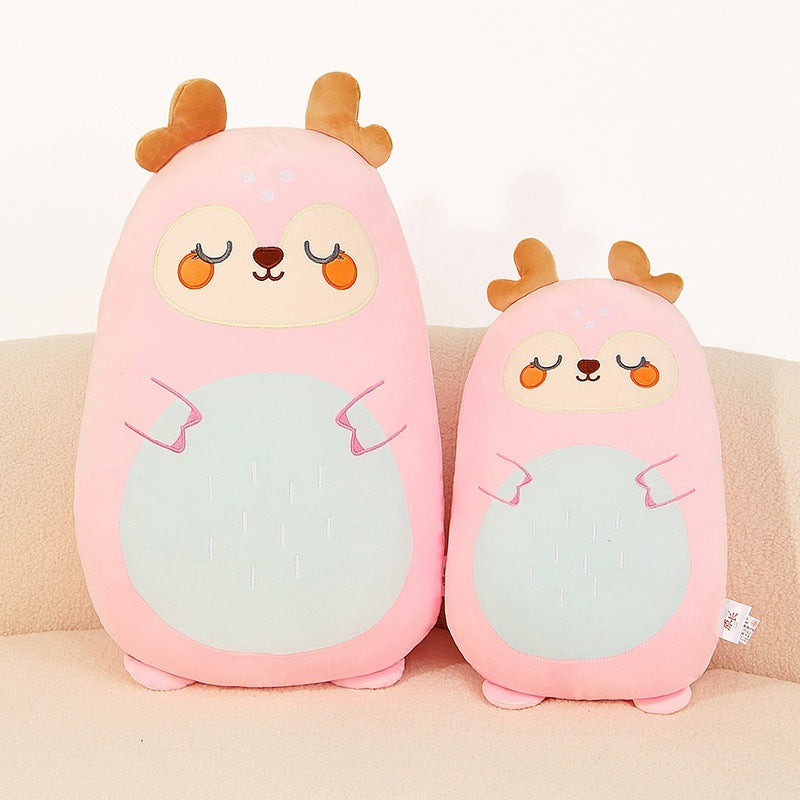 Two pink plush toys with animal faces on a beige couch.